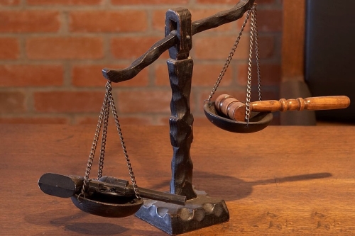 Gun vs Gavel on Scales