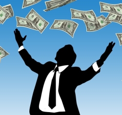 Shadowy figure in suit being showered with money