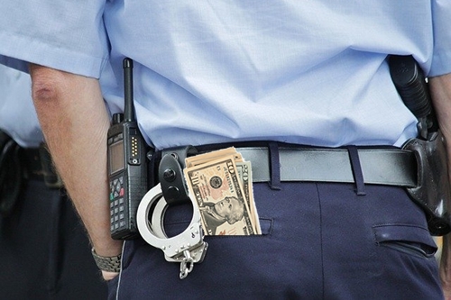 Cash Sticking Out of Police Officer's Back Pocket