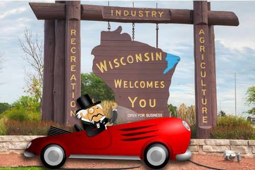 Rich Main in Sports Car in Front of Wisconsin Sign
