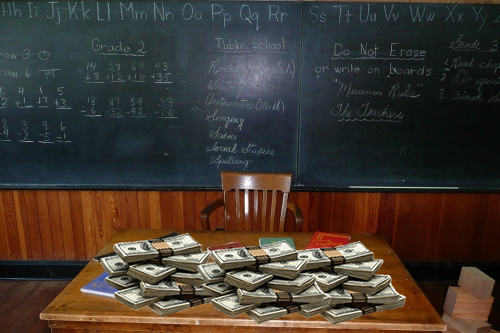 Teacher's Classroom Desk Covered by Cash