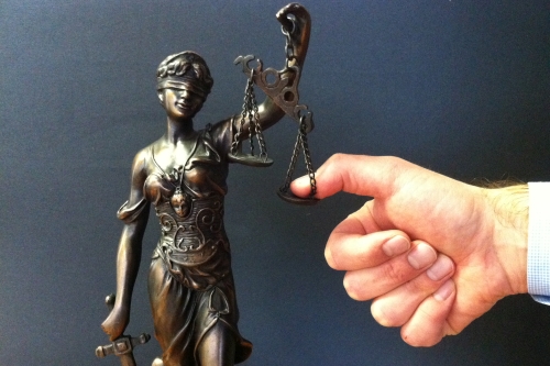 Thumb on Scales of Justice